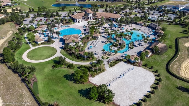 view of property location with a pool and a nearby body of water