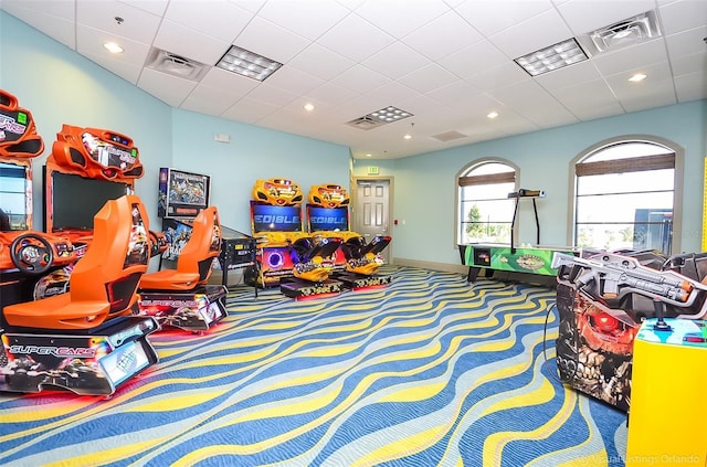 rec room with carpet, baseboards, recessed lighting, and a paneled ceiling