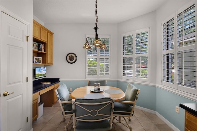 532 Casanova Ct, Kissimmee, FL 34759 - dining space with light tile patterned floors, healthy amount of natural light, baseboards, and a chandelier