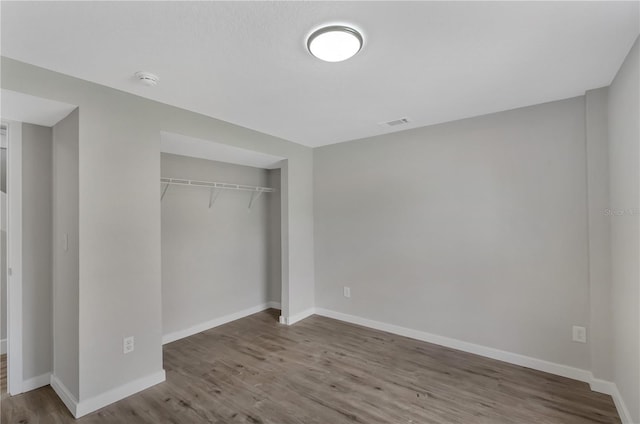1840 Lillian Dr, Saint Cloud, FL 34771 - unfurnished bedroom with wood finished floors, baseboards, and a closet