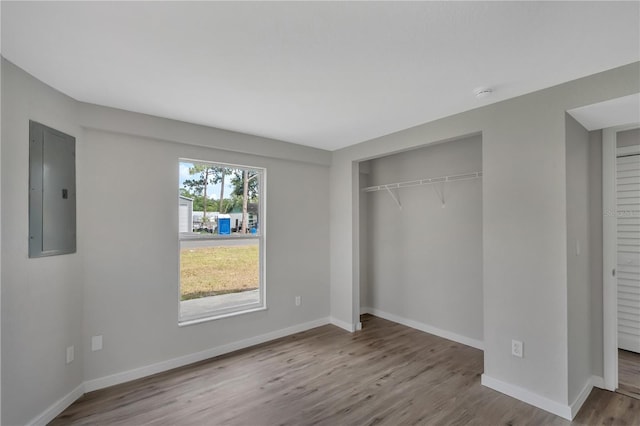 1840 Lillian Dr, Saint Cloud, FL 34771 - unfurnished bedroom featuring electric panel, wood finished floors, a closet, and baseboards
