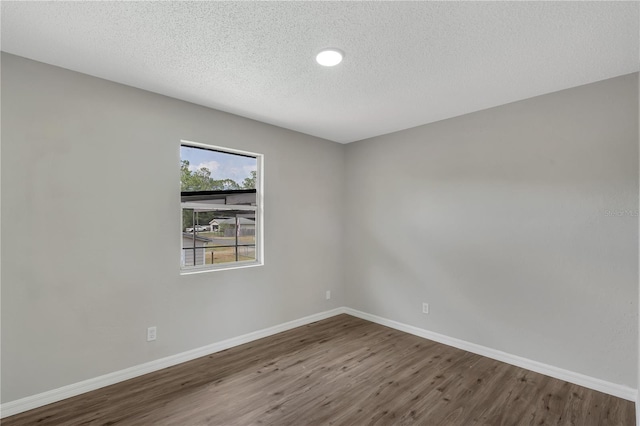 1840 Lillian Dr, Saint Cloud, FL 34771 - spare room with wood finished floors, baseboards, a textured ceiling, and recessed lighting