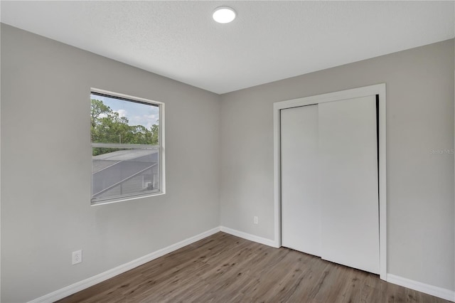 1840 Lillian Dr, Saint Cloud, FL 34771 - unfurnished bedroom with wood finished floors, baseboards, and a closet