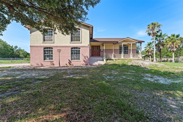 2500 Derby Dr, Kissimmee, FL 34744 - view of front facade featuring a porch, brick siding, and stucco siding