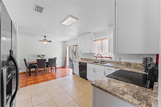 2500 Derby Dr, Kissimmee, FL 34744 - kitchen featuring refrigerator with ice dispenser, black dishwasher, a sink, stove, and white cabinetry