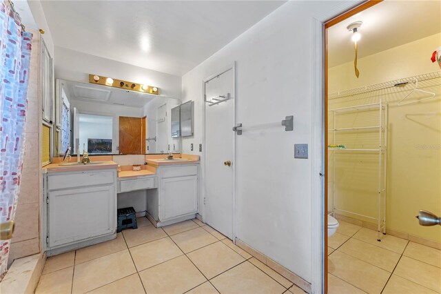 2500 Derby Dr, Kissimmee, FL 34744 - full bath with tile patterned floors, double vanity, and toilet