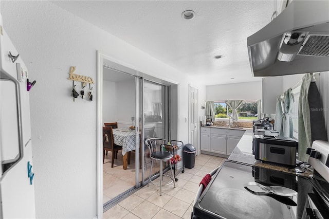 2500 Derby Dr, Kissimmee, FL 34744 - kitchen with under cabinet range hood, light tile patterned floors, gray cabinets, and a sink