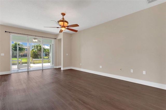 empty room with dark wood-style flooring, baseboards, and a ceiling fan