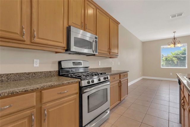 kitchen featuring appliances with stainless steel finishes, baseboards, a chandelier, light tile patterned floors, and pendant lighting