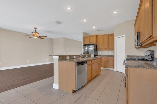 kitchen with appliances with stainless steel finishes, ceiling fan, light tile patterned floors, a sink, and recessed lighting