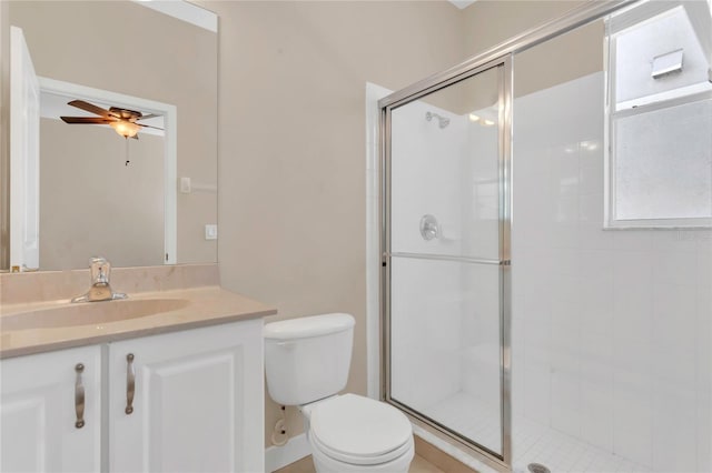 bathroom with ceiling fan, a stall shower, toilet, and vanity