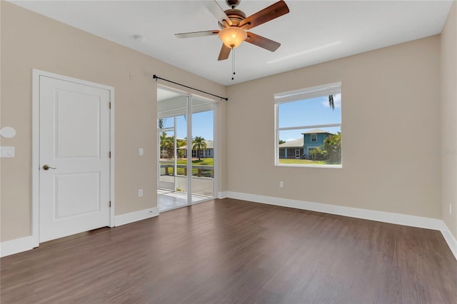 unfurnished room with wood finished floors, baseboards, and ceiling fan