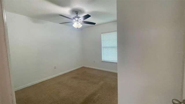 4450 Capital Blvd, Saint Cloud, FL 34769 - carpeted spare room with baseboards and ceiling fan