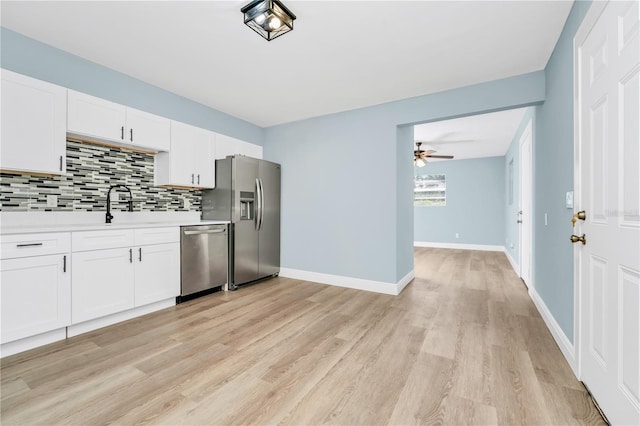 228 Ring Rd, Orlando, FL 32811 - kitchen featuring stainless steel appliances, a ceiling fan, backsplash, light countertops, and light wood-type flooring