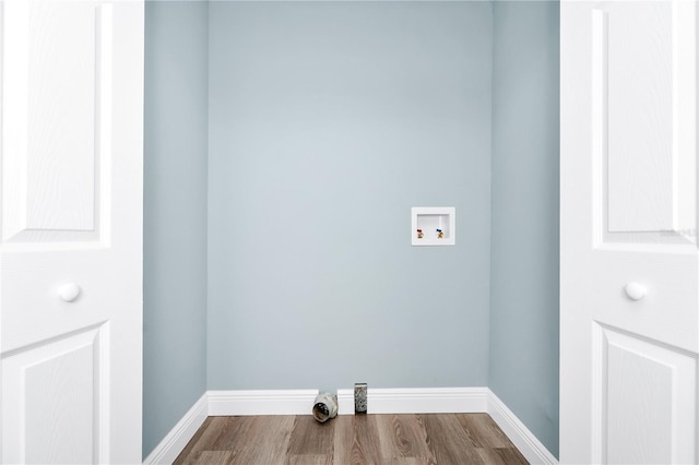 228 Ring Rd, Orlando, FL 32811 - laundry room with washer hookup, wood finished floors, and baseboards