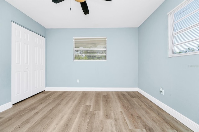 228 Ring Rd, Orlando, FL 32811 - unfurnished bedroom featuring wood finished floors, baseboards, and a closet
