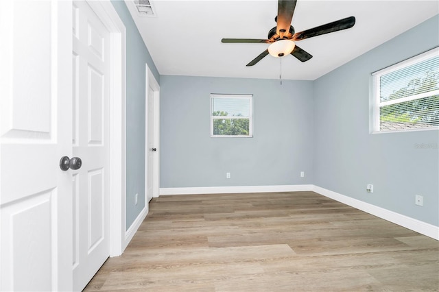 228 Ring Rd, Orlando, FL 32811 - unfurnished bedroom with light wood finished floors, baseboards, and ceiling fan
