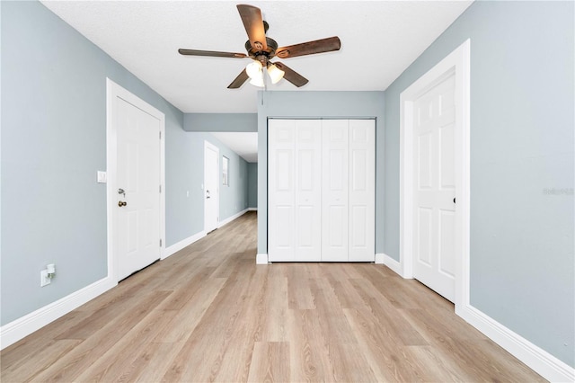 228 Ring Rd, Orlando, FL 32811 - unfurnished bedroom featuring light wood-type flooring, baseboards, a closet, and a ceiling fan