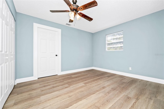 228 Ring Rd, Orlando, FL 32811 - unfurnished bedroom with a closet, light wood-style floors, baseboards, and a ceiling fan