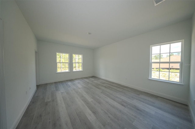 unfurnished room featuring wood finished floors and baseboards