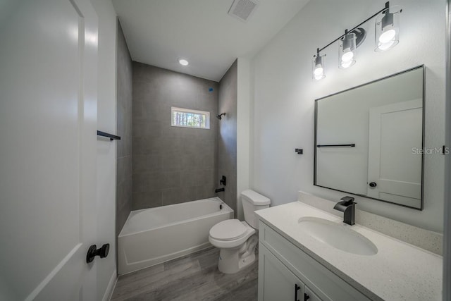 full bathroom with wood finished floors, toilet, washtub / shower combination, and vanity
