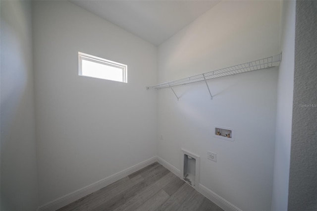 washroom featuring wood finished floors, hookup for a washing machine, hookup for an electric dryer, and baseboards