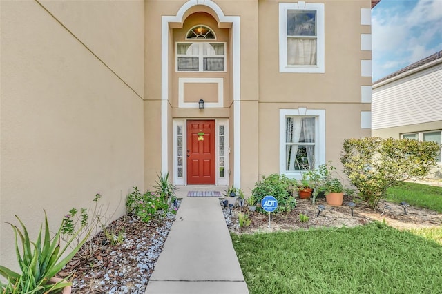 510 Lobelia Dr, Davenport, FL 33837 - doorway to property with stucco siding