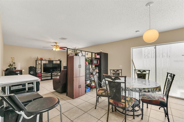 510 Lobelia Dr, Davenport, FL 33837 - dining room featuring light tile patterned floors, a textured ceiling, and a ceiling fan