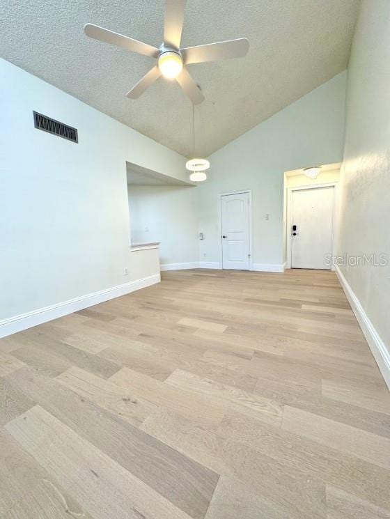3621 Atrium Dr Unit U-4, Orlando, FL 32822 - empty room featuring a ceiling fan, lofted ceiling, a textured ceiling, baseboards, and light wood-style flooring