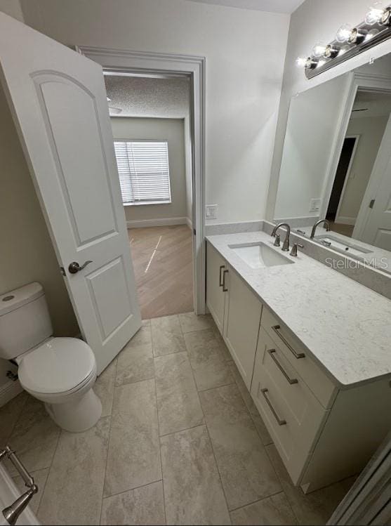 3621 Atrium Dr Unit U-4, Orlando, FL 32822 - bathroom with vanity, toilet, and baseboards