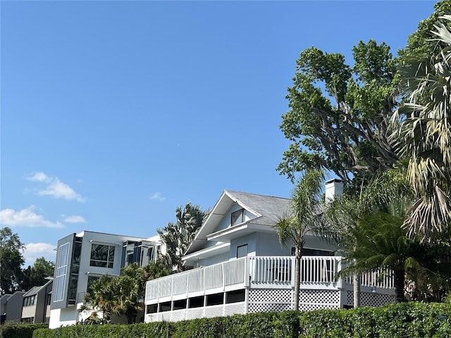 629 Helen St, Mount Dora, FL 32757 - view of home's exterior with a chimney