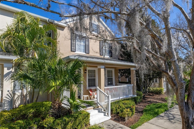 9141 Camden Gardens St, Orlando, FL 32827 - view of front of house featuring a porch and stucco siding