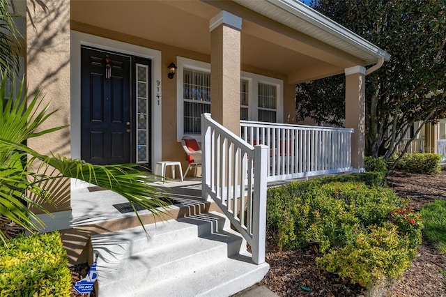 9141 Camden Gardens St, Orlando, FL 32827 - entrance to property featuring stucco siding and covered porch