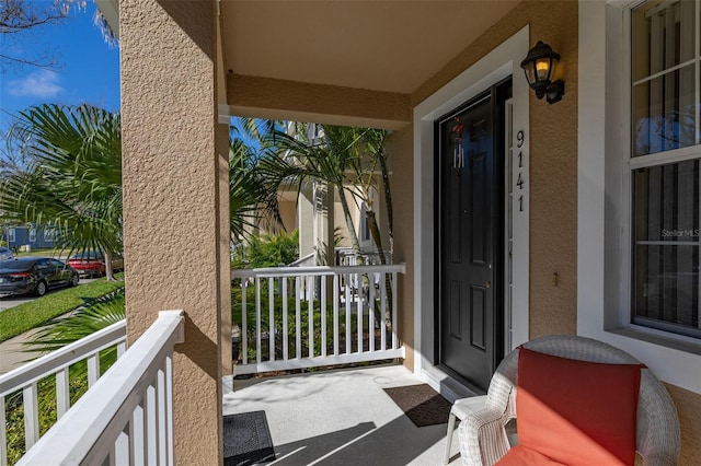 9141 Camden Gardens St, Orlando, FL 32827 - entrance to property with stucco siding and a porch