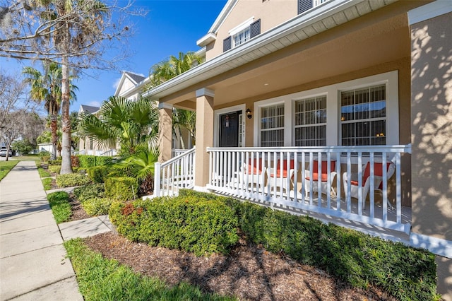 9141 Camden Gardens St, Orlando, FL 32827 - doorway to property with covered porch and stucco siding