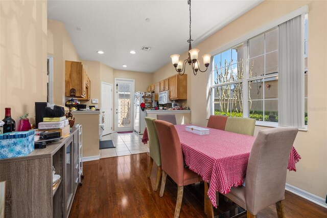 9141 Camden Gardens St, Orlando, FL 32827 - dining area featuring a chandelier, dark wood-type flooring, baseboards, and recessed lighting