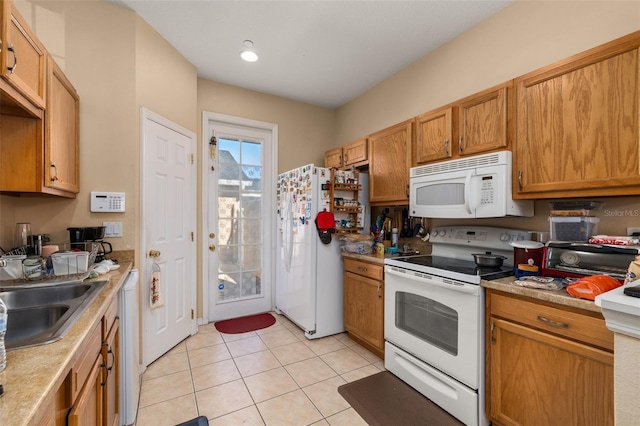 9141 Camden Gardens St, Orlando, FL 32827 - kitchen featuring white appliances, a sink, light tile patterned flooring, light countertops, and brown cabinets