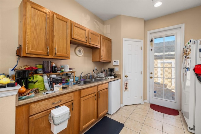 9141 Camden Gardens St, Orlando, FL 32827 - kitchen with freestanding refrigerator, a sink, dishwasher, light countertops, and light tile patterned floors