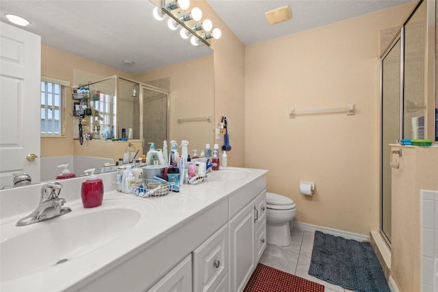 9141 Camden Gardens St, Orlando, FL 32827 - bathroom with a stall shower, double vanity, tile patterned flooring, and toilet