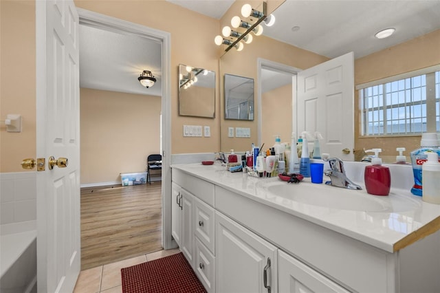 9141 Camden Gardens St, Orlando, FL 32827 - full bath with double vanity, tile patterned floors, and a bathtub