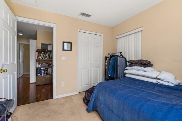 9141 Camden Gardens St, Orlando, FL 32827 - bedroom featuring a closet, baseboards, and light carpet