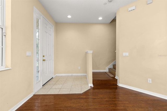 9141 Camden Gardens St, Orlando, FL 32827 - foyer entrance featuring wood finished floors, stairs, and recessed lighting