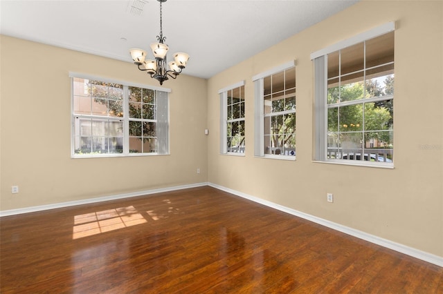 9141 Camden Gardens St, Orlando, FL 32827 - unfurnished room with a chandelier and wood finished floors
