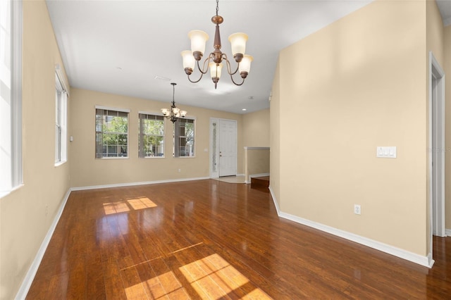 9141 Camden Gardens St, Orlando, FL 32827 - spare room with a chandelier and wood finished floors