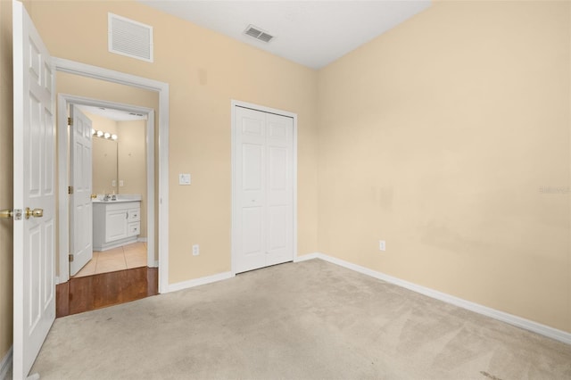 9141 Camden Gardens St, Orlando, FL 32827 - unfurnished bedroom featuring light carpet and a closet