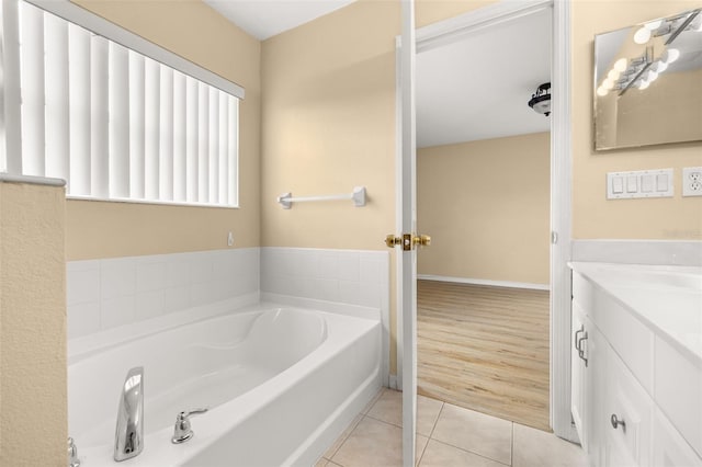 9141 Camden Gardens St, Orlando, FL 32827 - full bathroom with vanity, a garden tub, and tile patterned flooring