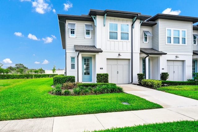 809 Benoi Dr, Davenport, FL 33896 - view of property featuring concrete driveway, a front lawn, board and batten siding, and a garage