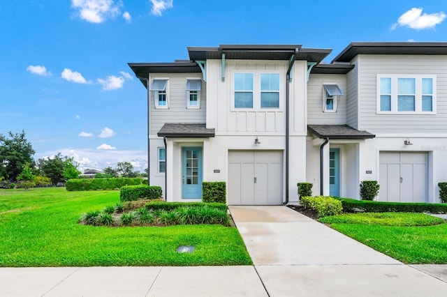 809 Benoi Dr, Davenport, FL 33896 - view of property with a front lawn, driveway, an attached garage, and board and batten siding