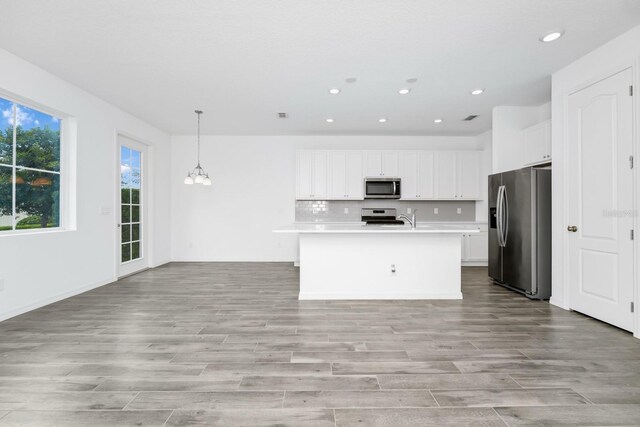 809 Benoi Dr, Davenport, FL 33896 - kitchen with stainless steel appliances, a chandelier, light wood-style flooring, light countertops, and recessed lighting