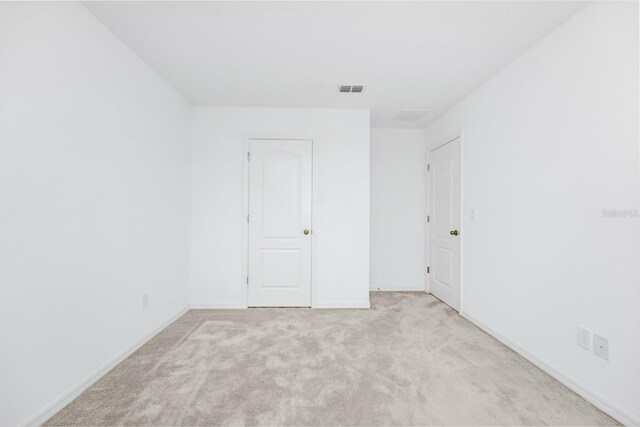809 Benoi Dr, Davenport, FL 33896 - unfurnished bedroom featuring light colored carpet and baseboards